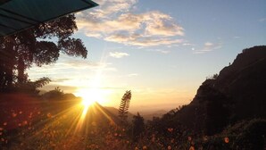 A sunset over a mountainous landscape with a clear sky. - Blue Ribbon Homestay  (Ella)