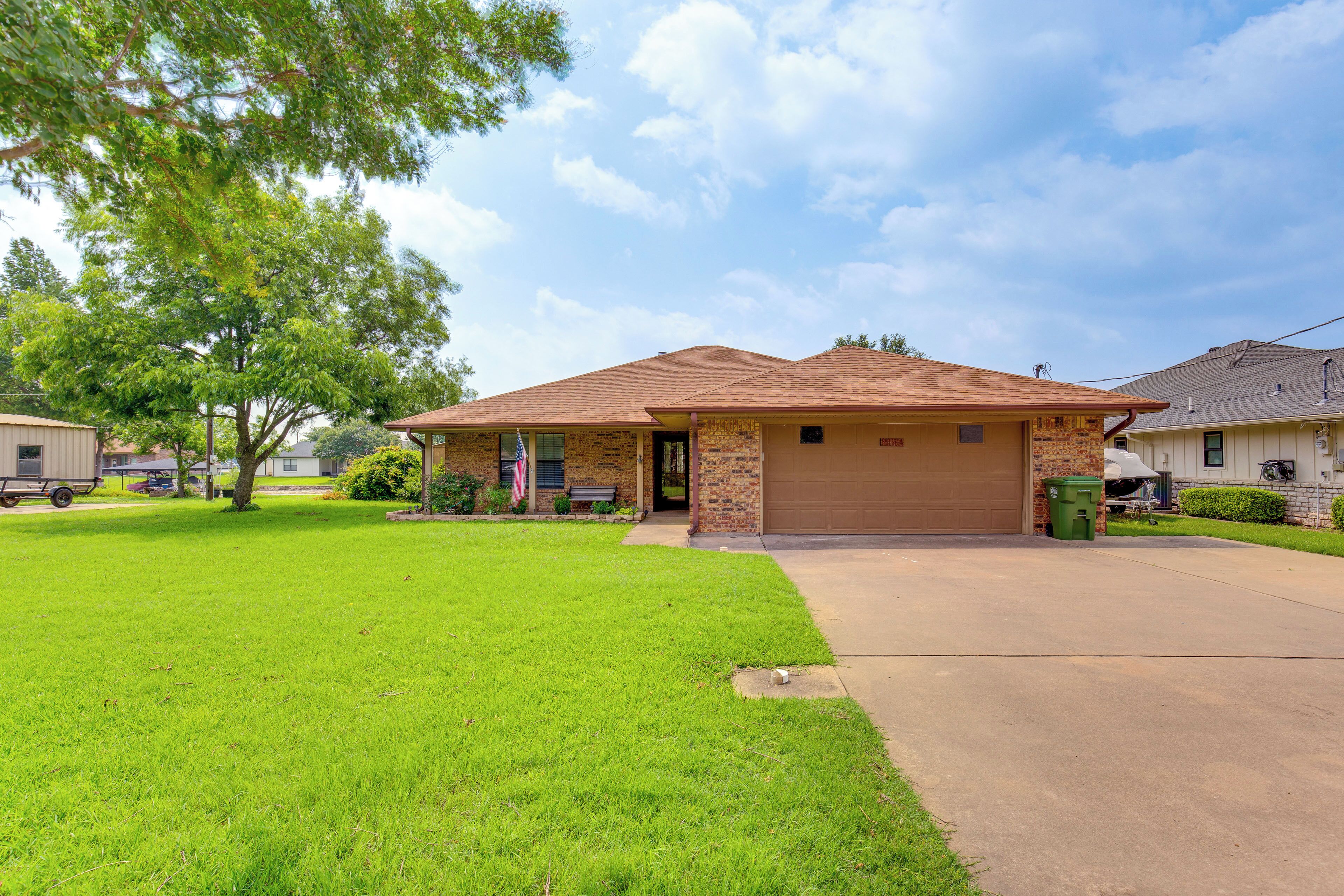 A single-story house with a brown roof and a garage door.