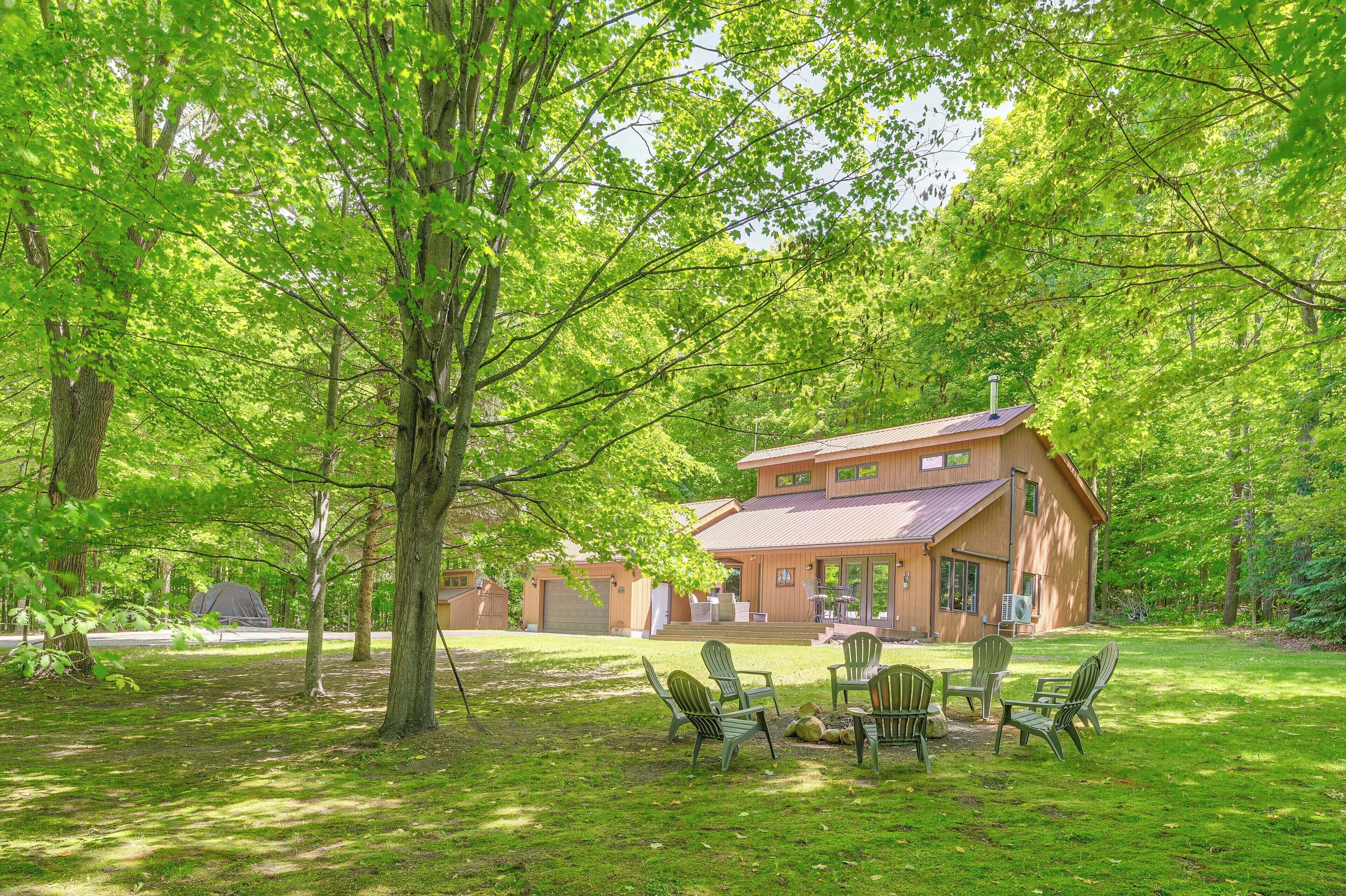 A wooden house with a covered patio and outdoor seating area.