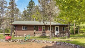 A cabin with a stone foundation, wooden exterior, and a porch. - Updated Conover Cabin w/ Nearby Boating Access! (Conover)