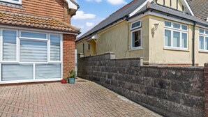 A residential property with a brick pathway, a stone wall, and a tiled roof. - Boutique Studio Apartment By My Getaways (Brighton)