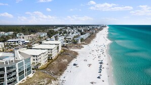A coastal town with a long sandy beach, beachfront properties, and a clear blue sky. - Incredible 4BD, 3BA, GULF-FRONT, LG. PATIO, POOL, GRILL, PRIVATE BEACH (Santa Rosa Beach)
