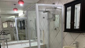 A modern bathroom with a glass shower enclosure, a white pedestal sink, and a mirror cabinet. - Saba Saba Guest House (Pretoria)