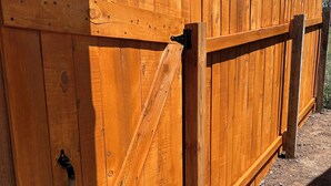 A wooden fence with a metal gate. - One room guest house with hot tub, three twin beds, one futon, kitchen, bathroom (Collbran)
