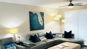 A modern living room with a sectional sofa, a chaise lounge, and a patterned rug. - Perfect Getaway! Naples, Walk To Vanderbilt Beach -Immaculate! (Naples)