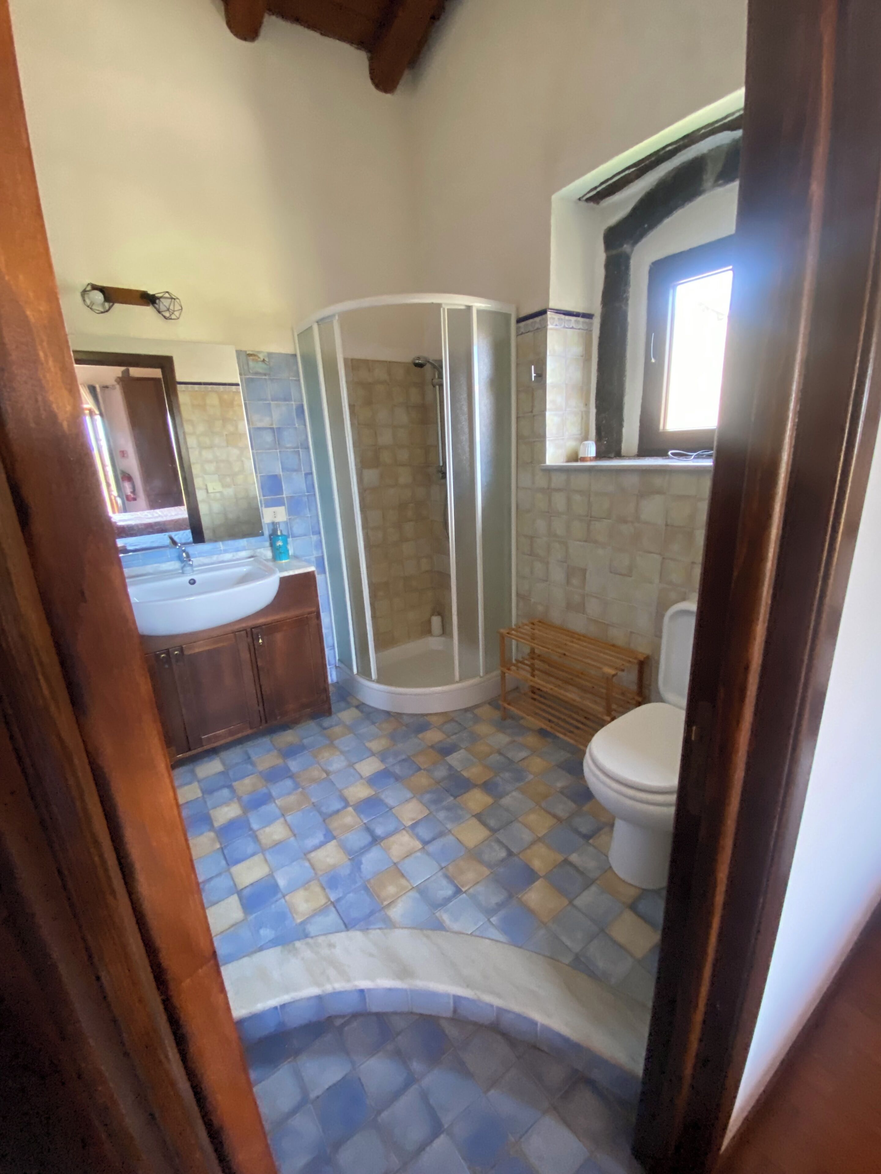 A bathroom with a shower, toilet, and sink.
