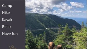 A scenic view of a mountainous landscape with a road cutting through the valley. - The Riverside Dutchmen.  Reconnect with nature (Petit Étang)