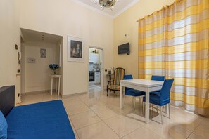 Apartment | Living area | 35-inch TV with digital channels - Olivella Apartment al Teatro Massimo by Wonderful Italy (Palermo)