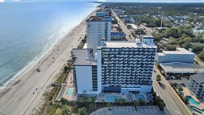 Un hotel con piscina, posizione fronte mare e diversi piani.