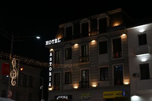 A hotel with a prominent sign, multiple windows, and string lights. - Astoria Hotel Zugdidi (Zugdidi)