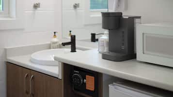 Una cocina moderna equipada con cafetera, microondas y pileta.