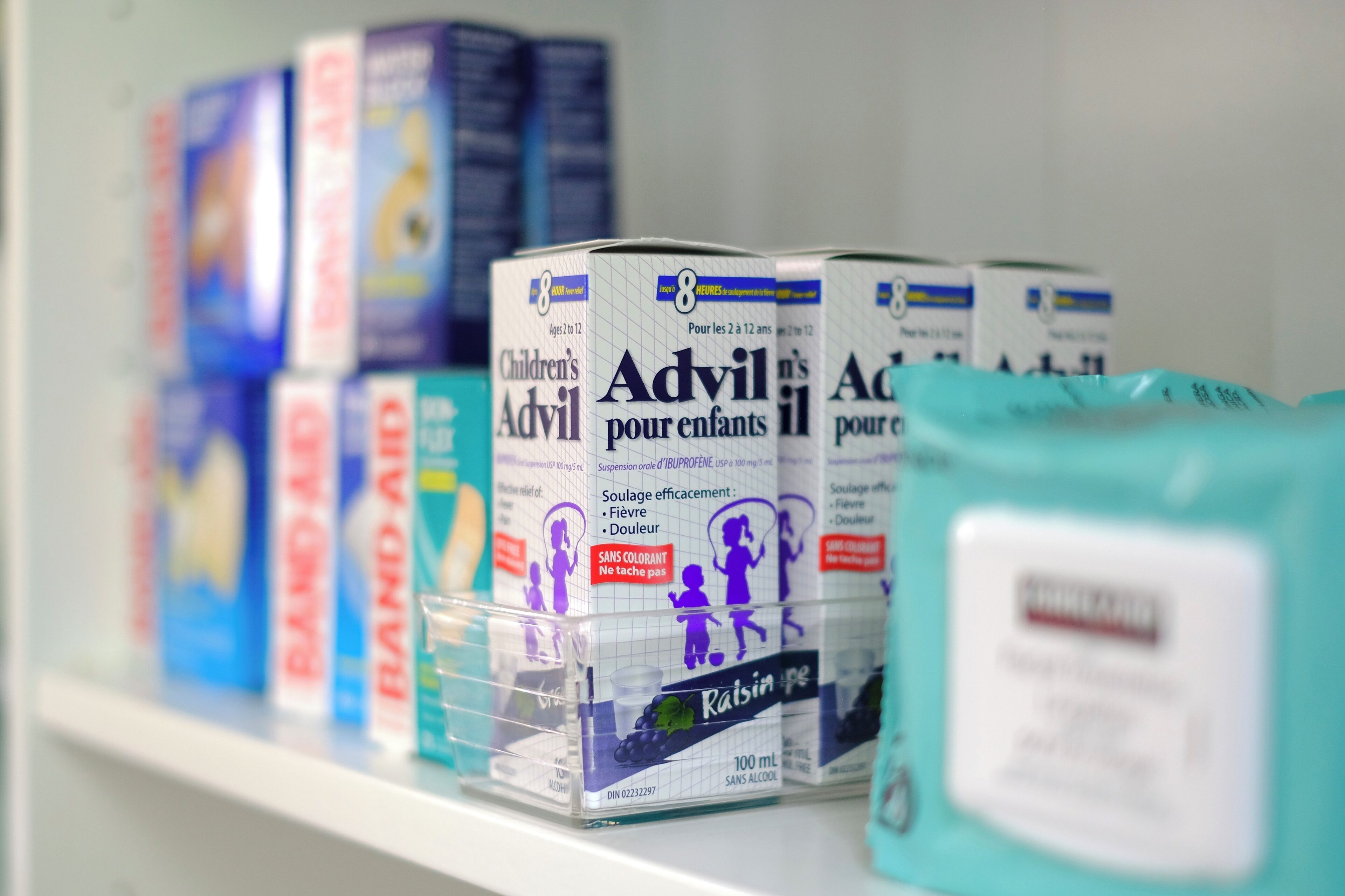 A shelf with various children's products, including boxes of Advil and other health-related items.