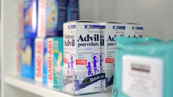 A shelf with various children's products, including boxes of Advil and other health-related items.