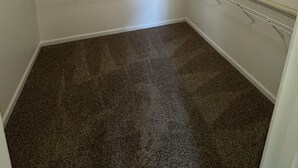 A corner closet with built-in shelving, carpeted floor, and a ceiling light fixture. - Cozy 4 bedroom family getaway home. Pet friendly home.  (Turlock)