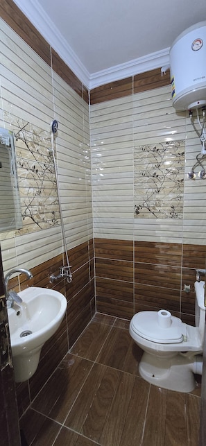 Habitación triple básica | Baño | Regadera, amenidades de baño gratuitas, secadora de cabello, toallas