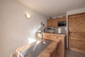 A kitchen with wooden cabinets, a built-in oven, and a countertop.