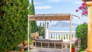 A poolside area with a pergola, seating, and a view of the sea. - Holiday Home 'Chalet Altea' with Sea View, Wi-Fi and Air Conditioning (Altea)