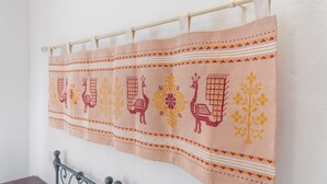 A patterned fabric hanging on a rod.
