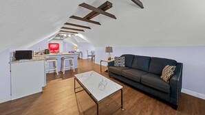 A compact living space with a kitchen, dining area, and a couch. - Loft - Enjoy peaceful living in downtown (Kansas City)