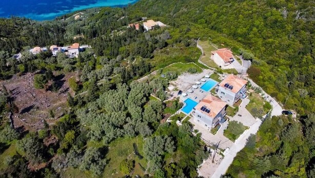 An aerial view of a coastal property with multiple buildings, a swimming pool, and a forested hillside. - Studio Apartment '3' with Sea View, Wi-Fi and Air Conditioning (?e???da)