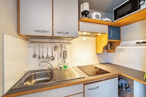 Een koelkast, een magnetron, een kookplaat, een vaatwasser