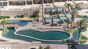 A resort with a large pool area, multiple lounge chairs, and a covered seating area. - Las Palomas Opalo 502 Exceptional Oceanview 1BR 1BA Unit (Puerto Peñasco)