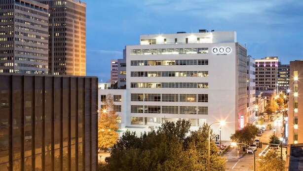 A modern building with multiple floors, large windows, and a prominent 'On Third' sign.