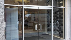 A building entrance with a glass door displaying the number 440 and the text "ON THIRD".