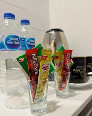 A kitchen counter with various coffee pods and a water dispenser. - Bei Otto Haus (Bangkok)