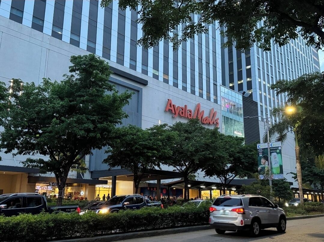 A modern building with a prominent sign for Ayala Mall.
