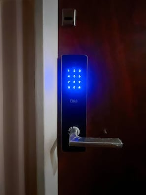 A blue electronic keypad lock on a door.
