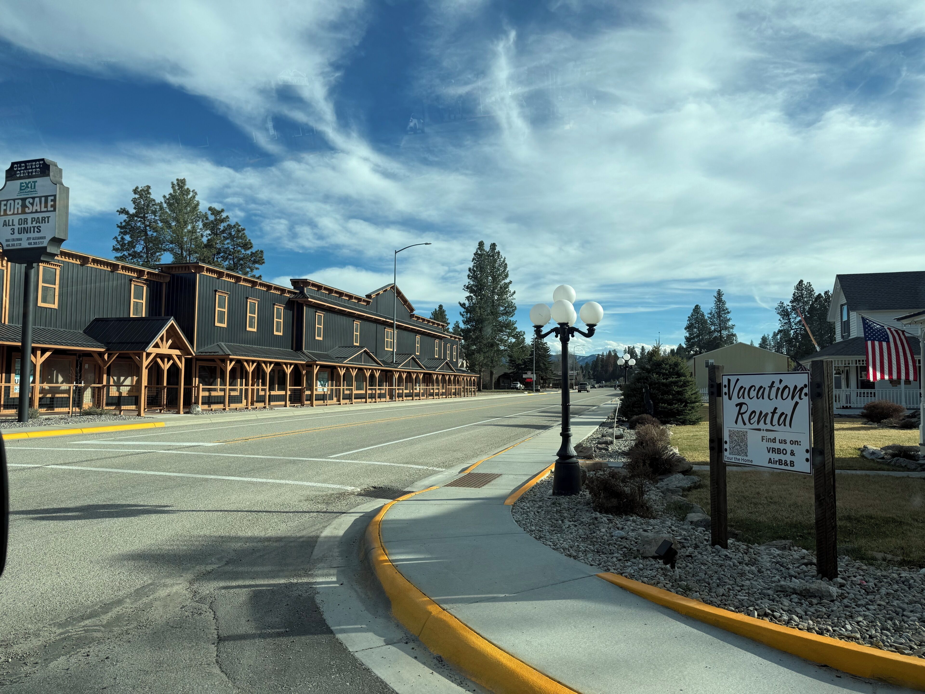 A street view with a building labeled 'Old West Center' and a sign for 'Vacation Rental.'
