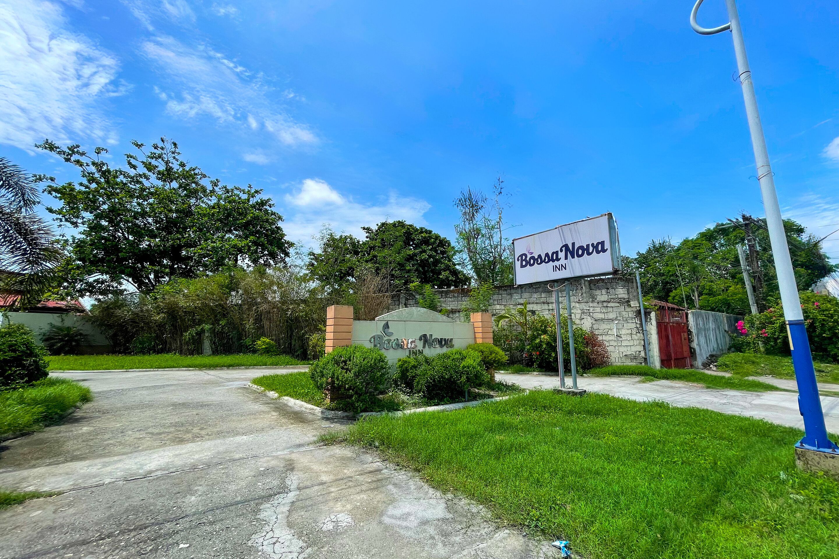 A hotel entrance with a sign reading "Bossa Nova Inn."