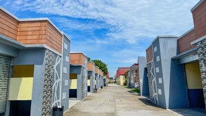 A row of modern buildings with a clear sky. - Casanova Inn (Bamban)