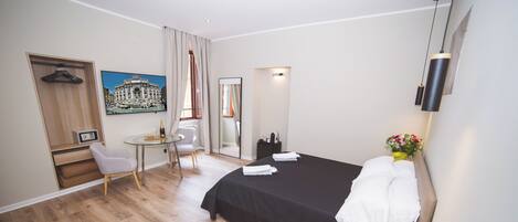 Deluxe Quadruple Room | In-room safe, blackout drapes, soundproofing, iron/ironing board