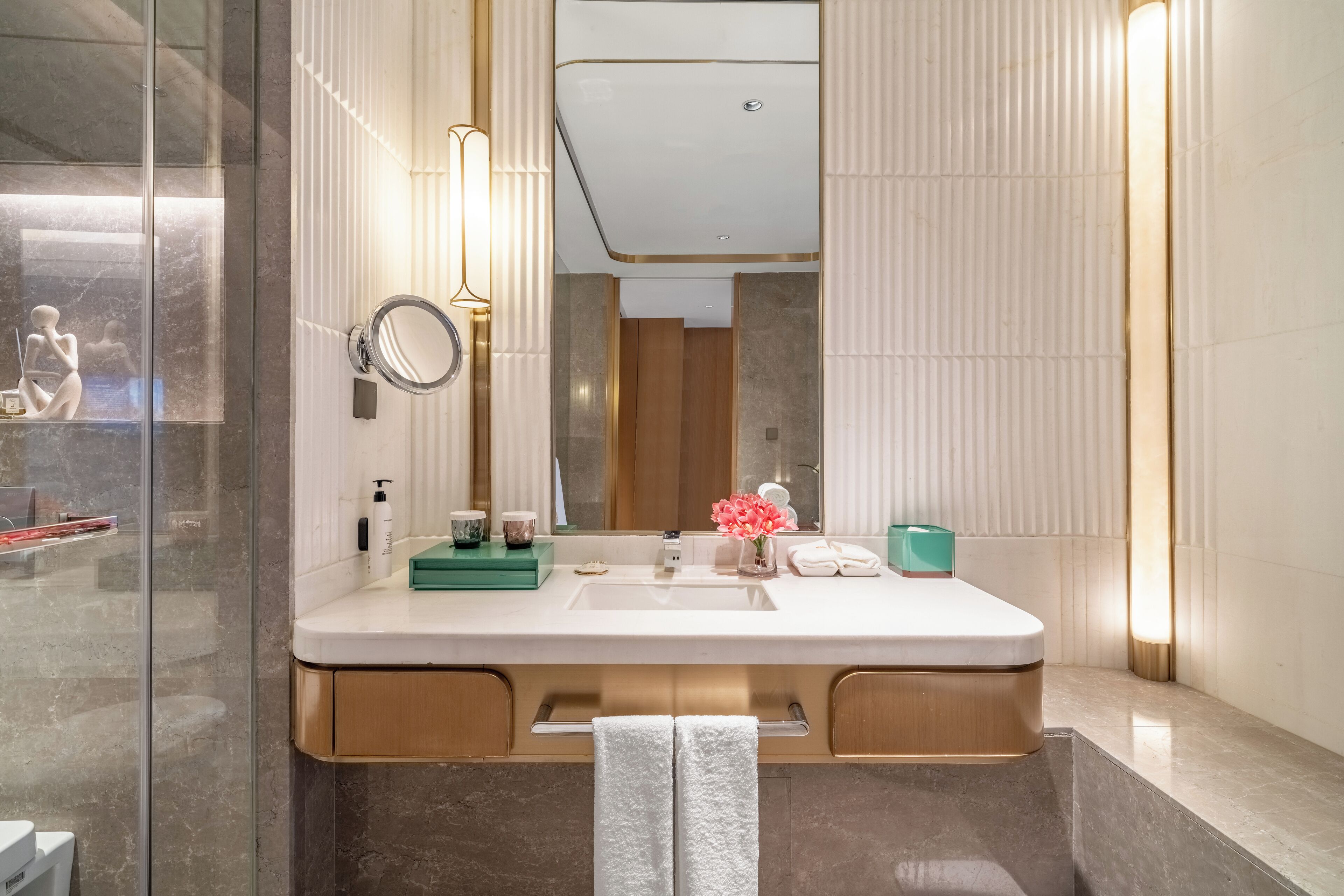 A modern bathroom with a large mirror, a sink, and a vanity.