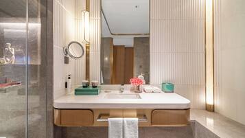 A modern bathroom with a large mirror, a sink, and a vanity.