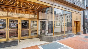 A theater entrance with a marquee reading "BIG LAUGH LOFTS" and a sign for "FORT WORTH".