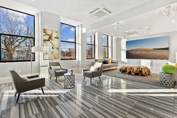 Sophisticated lobby lounge with floor-to-ceiling windows and contemporary furniture perfect for working remotely.