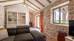 A cozy living room with a sofa, a wooden barrel, and a television. - Gorgeous home in Vinjerac (Vinjerac)