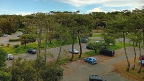 A parking area with several cars and trees. - Seaside Retreat: Cozy 1BR Apt Steps from Beach & Shops (Seignosse)