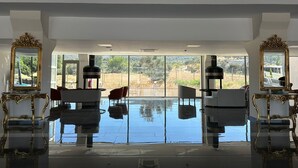 A spacious room with large windows, a reflective floor, and ornate furniture. - Etruscan Boutique Hotel (Eceabat)