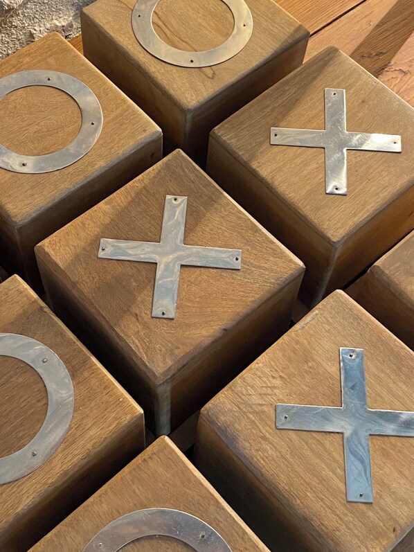 A collection of square wooden blocks with metal cross-shaped cutouts.