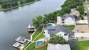 A residential area with houses, a dock, and a swimming pool. - The Escape at 212 | Concierge Services | Promos Available (Burnet)