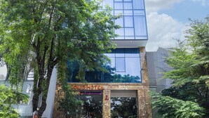 A modern hotel building with a glass facade, a visible entrance, and a sign reading "Solis Hotel." - Solis Hotel (Hai Phong)
