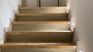 Una escalera de madera con una puerta al final.