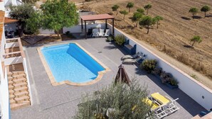 A rooftop pool area with a view of a hilly landscape. - Monte da Eirinha (Mertola)