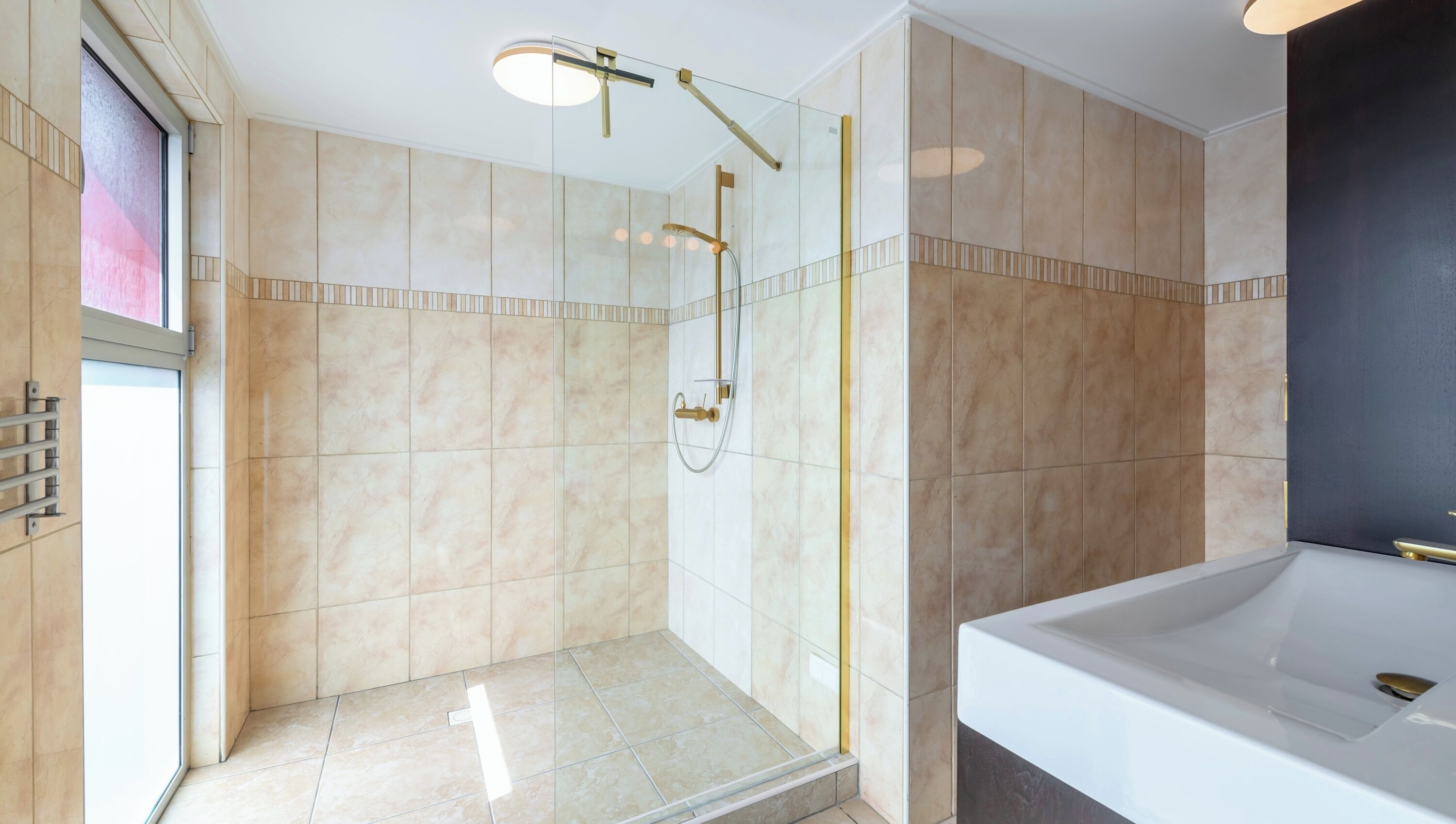 A modern bathroom with a walk-in shower, a bathtub, and a large mirror.