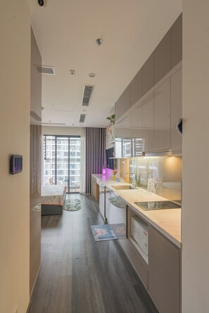 Business appartement | Privékeuken | Een koelkast, een kookplaat, een rijstkoker, kookgerei, borden en bestek