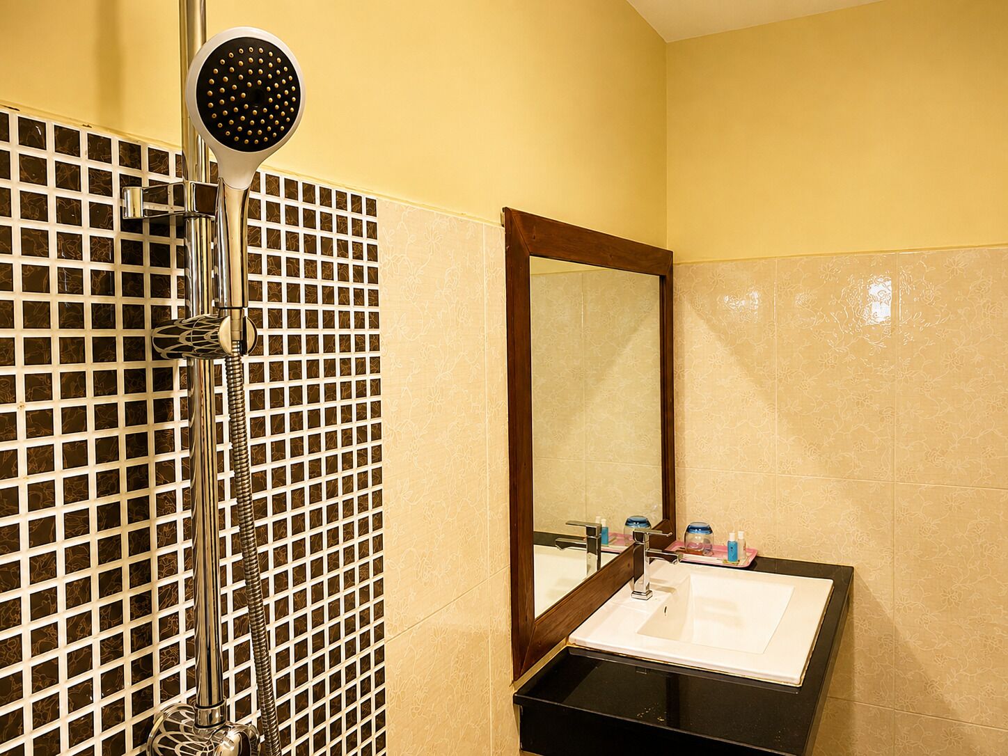 A bathroom with a shower, a sink, and a mirror.
